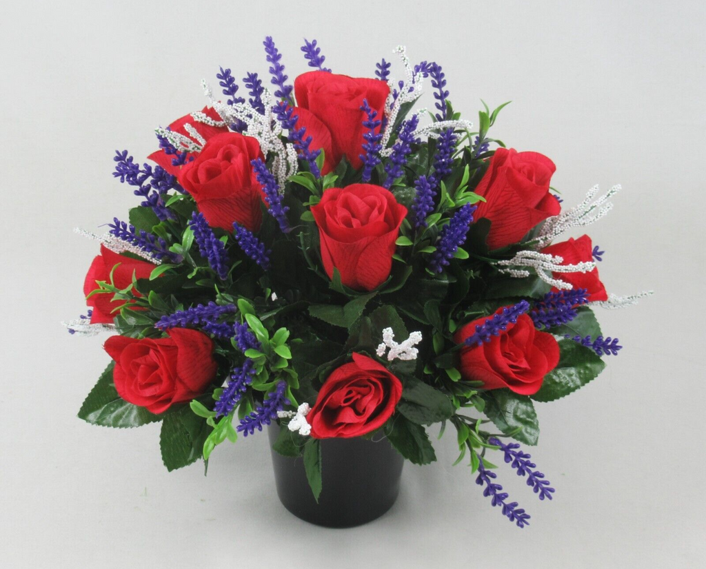 Artificial flower memorial grave pot: red roses, purple lavender sprigs, white tinsel stems