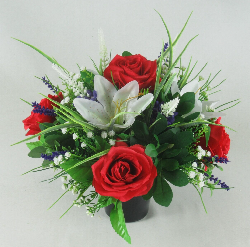 Artificial flower memorial urn with red roses, white lily, blue sprigs and greenery