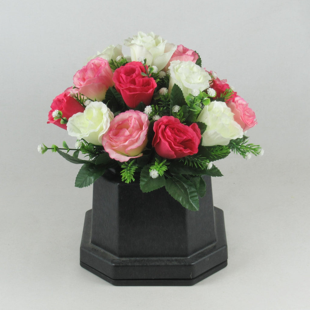 Front view memorial grave arrangement with pink and ivory artificial roses in black pot