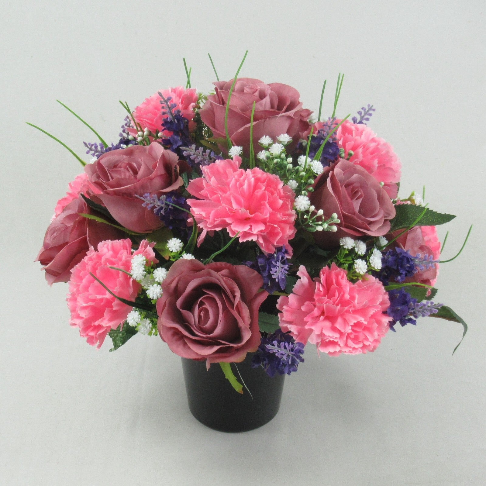 Artificial silk memorial cremation pot floral arrangement, mauve rose blooms with pink carnations