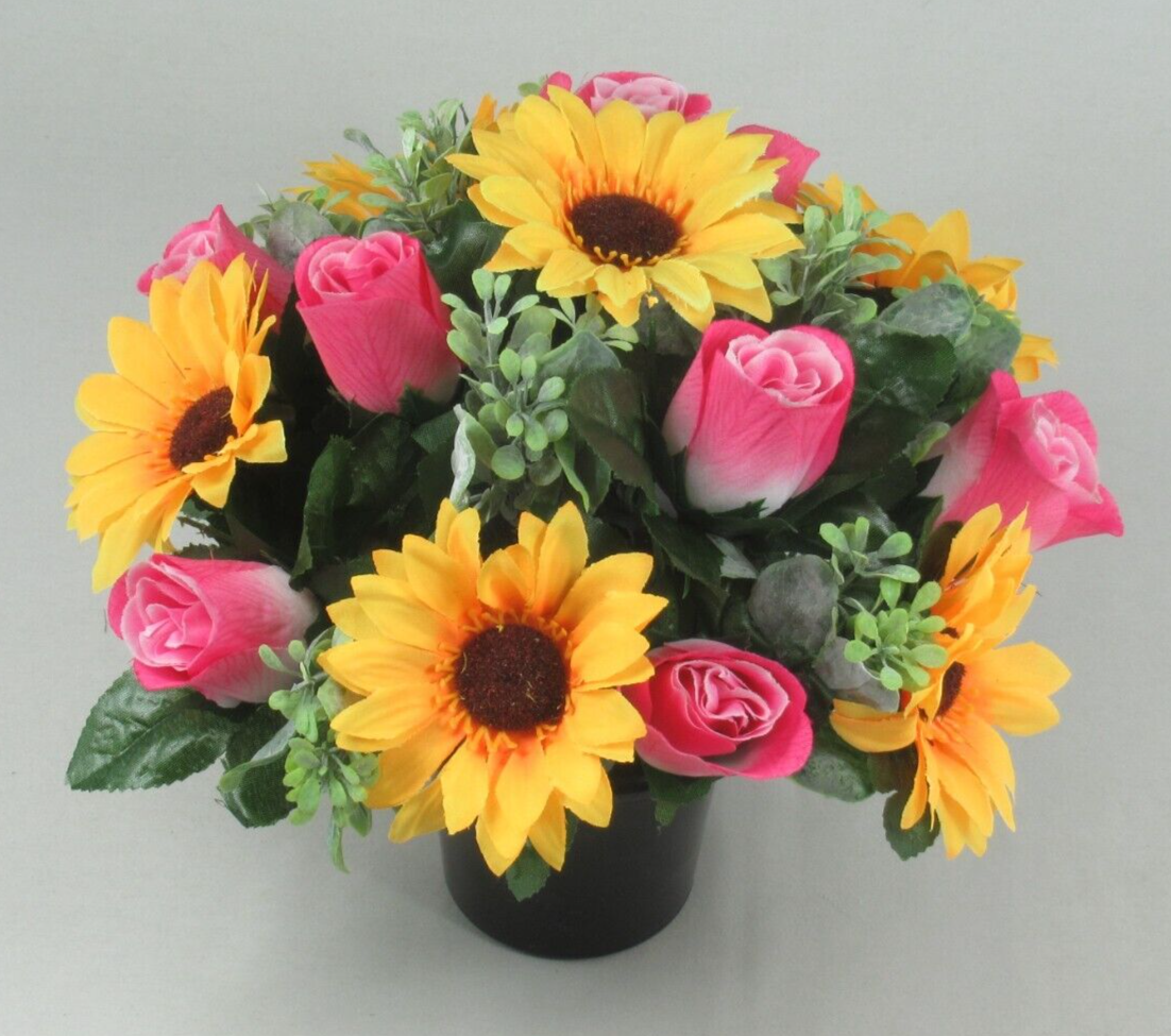 Black crem pot arrangement with artificial yellow sunflowers, pink roses, and green leaves