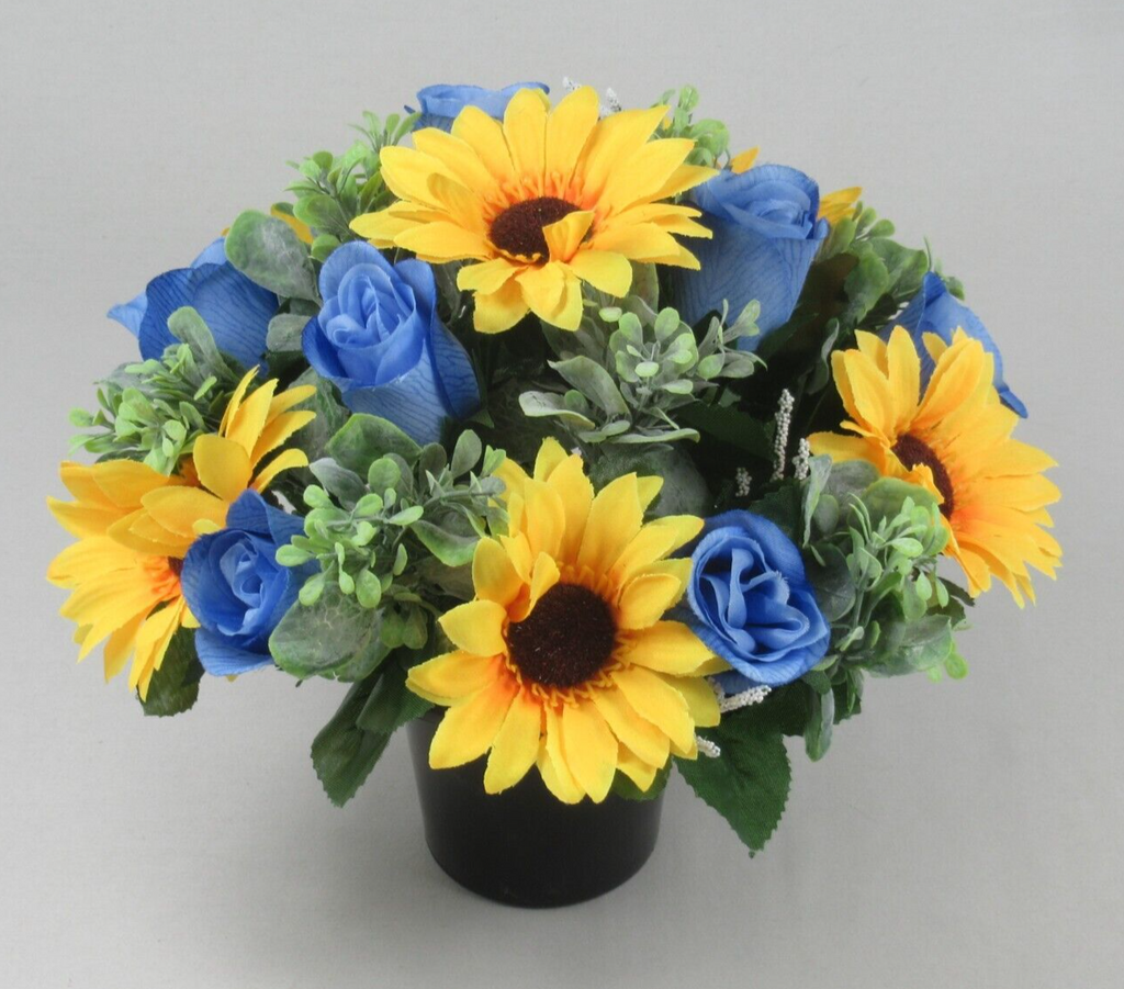Artificial memorial grave pot flowers with blue roses, yellow sunflowers, green foliage