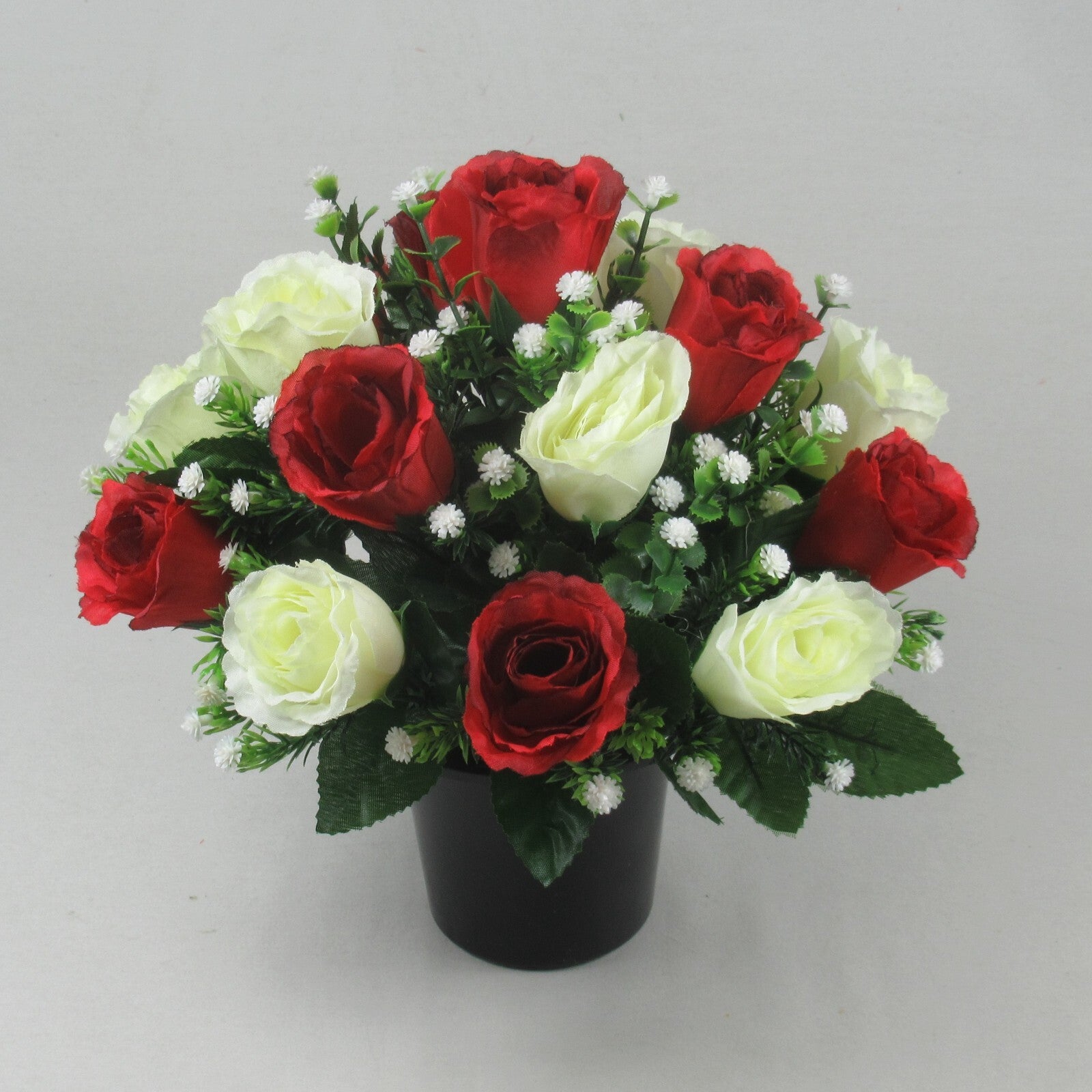 Artificial rose grave arrangement in black pot, red and ivory faux roses with greenery