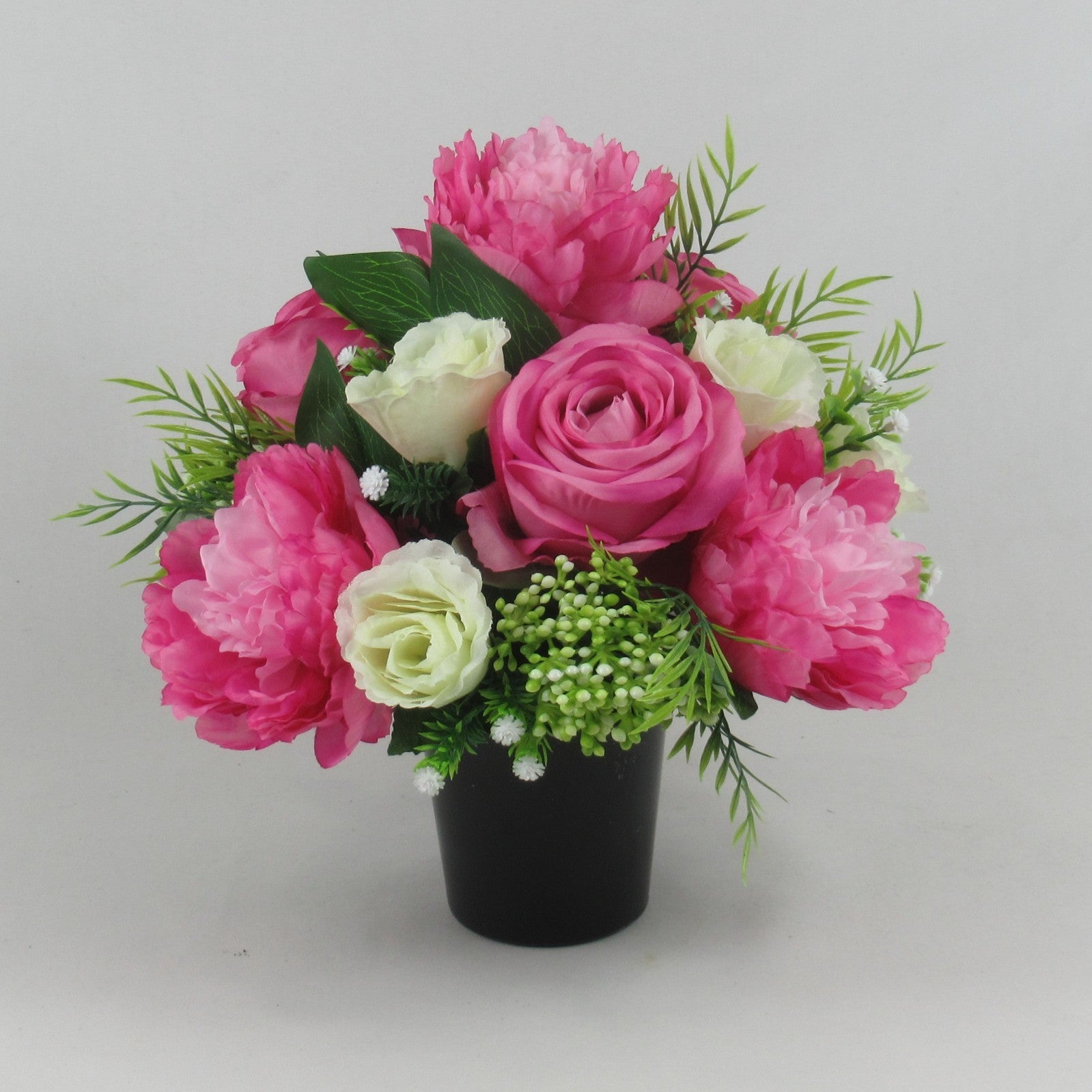 Pink and cream artificial rose and peony grave memorial bouquet, green buds, black vase