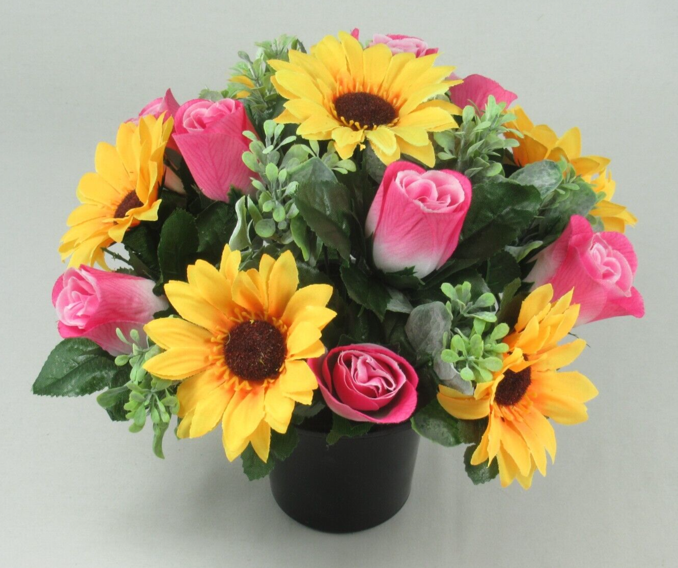 Front view of artificial memorial pot: yellow sunflowers, pink roses, and green foliage