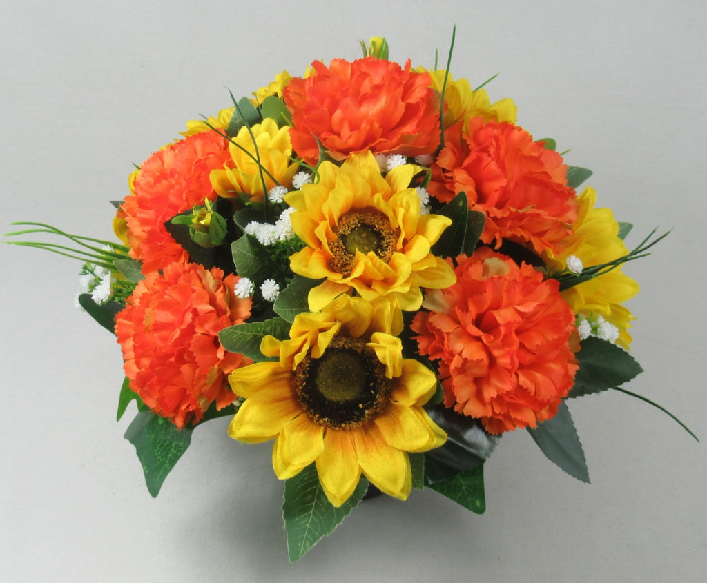 Artificial memorial grave pot flowers with orange and yellow sunflowers and carnations