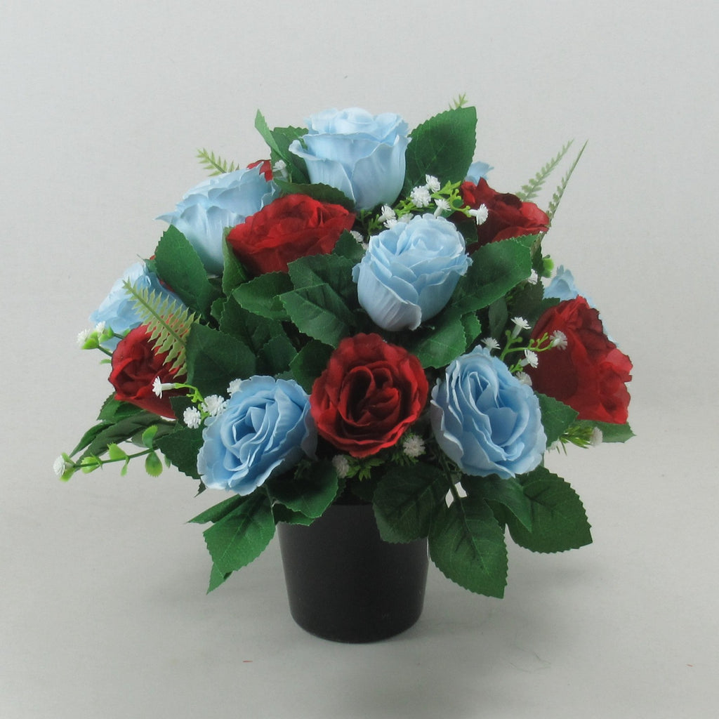 Artificial grave rose arrangement with red and light blue blooms in a black pot