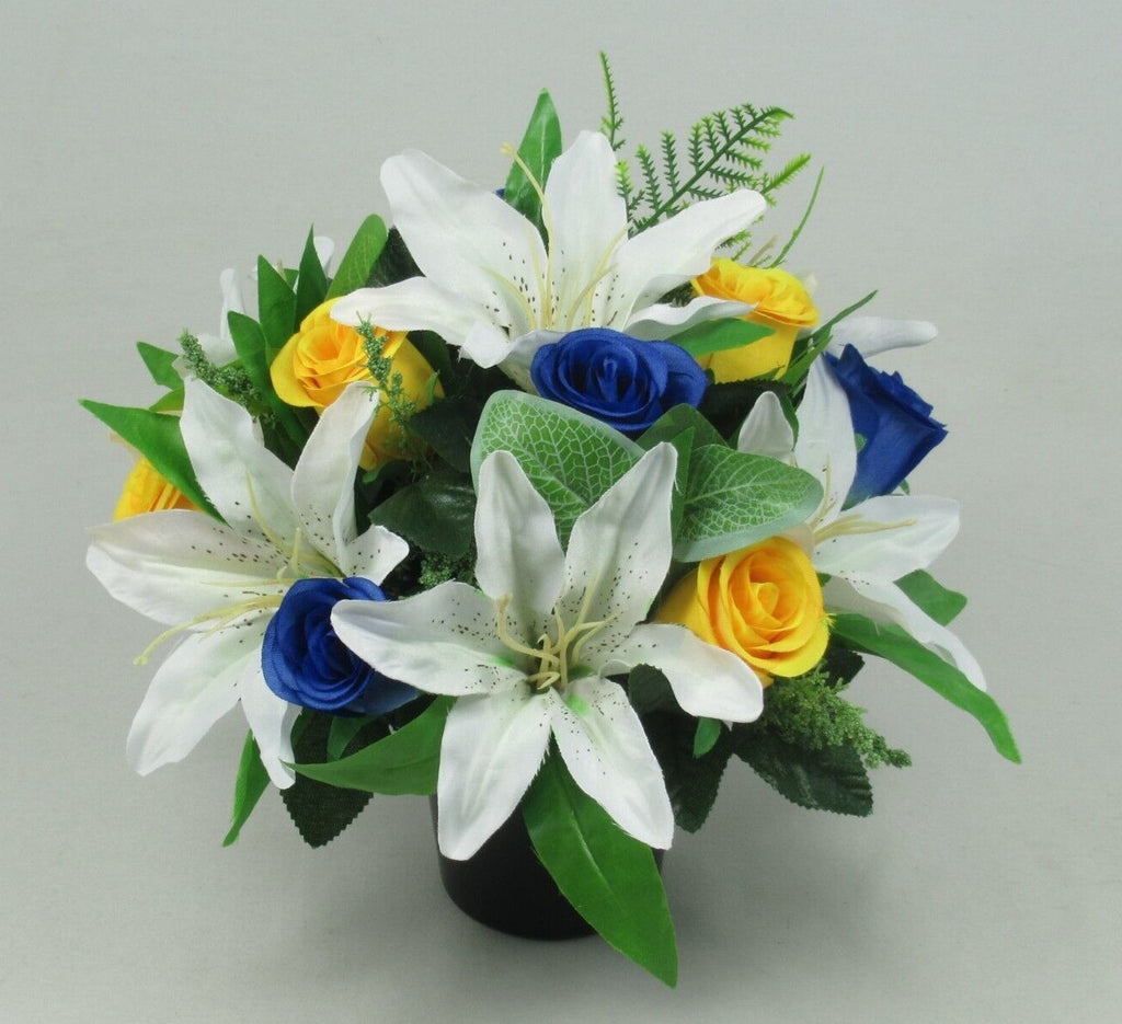 Artificial silk memorial grave arrangement in black pot with white lilies and blue/yellow roses