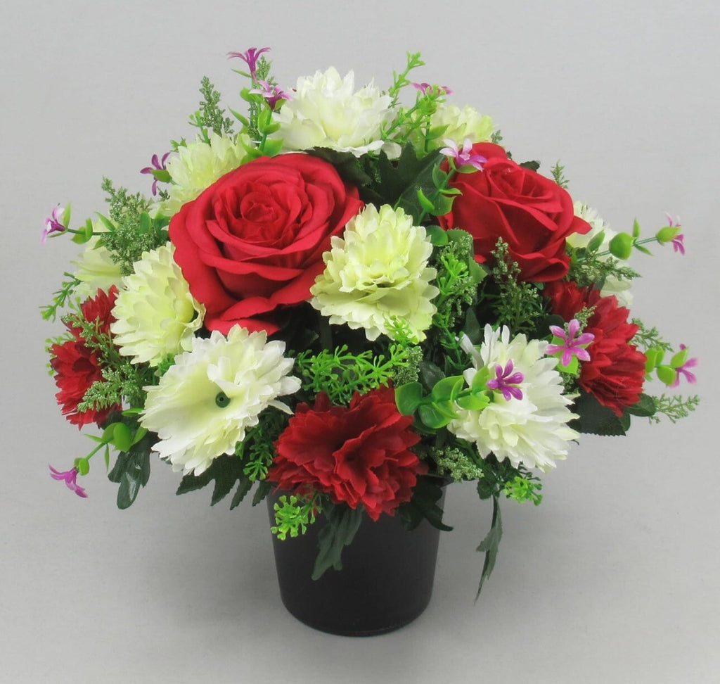 Artificial floral crem pot display: red roses, white blooms, green leaves, black pot