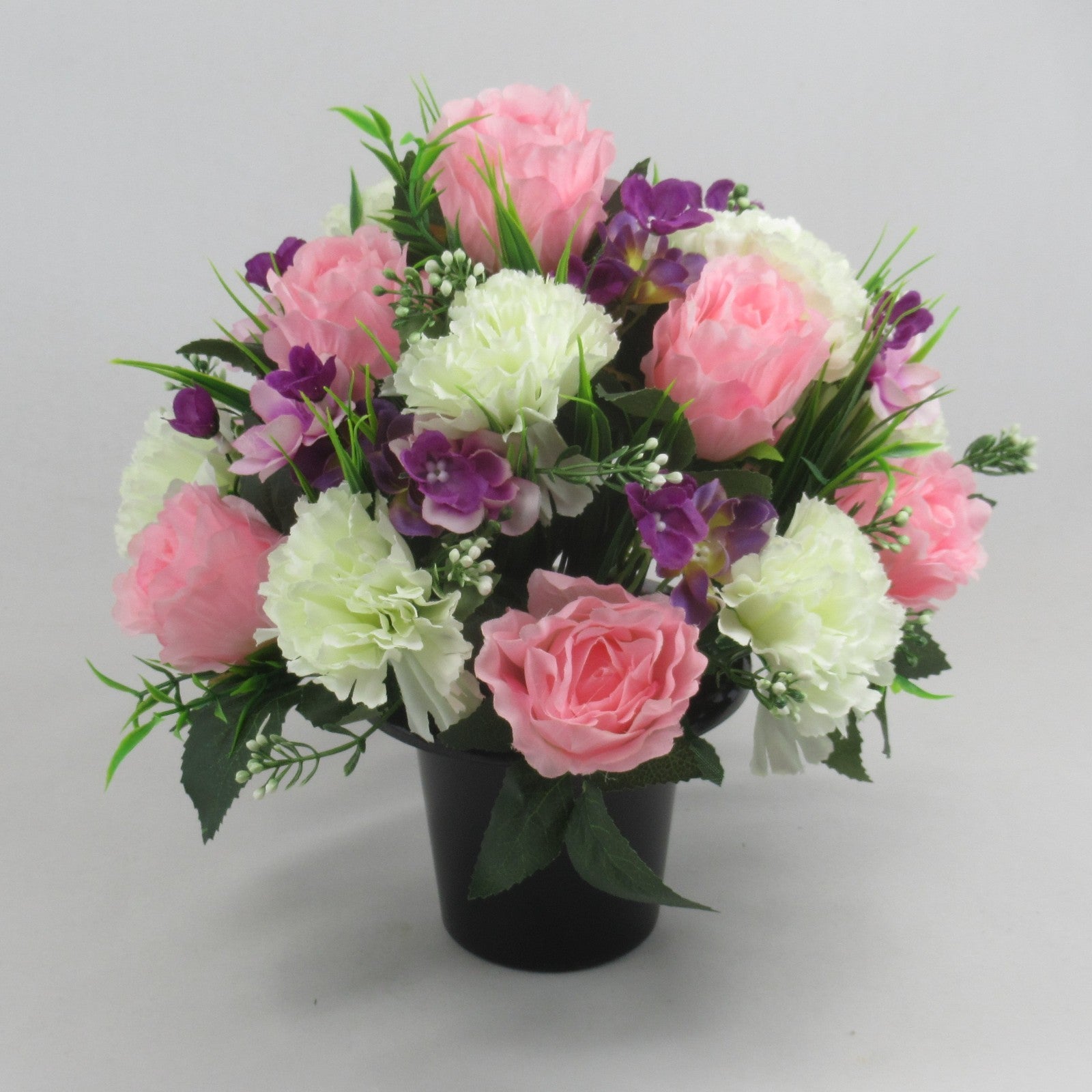 Silk grave arrangement, pink roses and buds with white and purple flowers in black vase