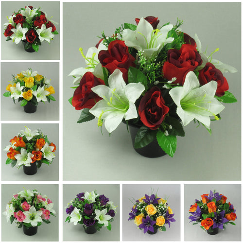 Artificial grave memorial flower arrangement in dark pot with red roses, white lilies, greenery
